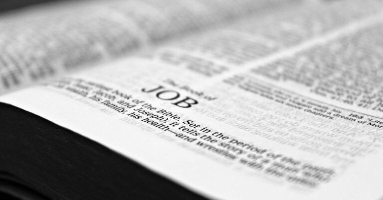 Close-up black and white image focusing on a Bible page with the Book of Job.