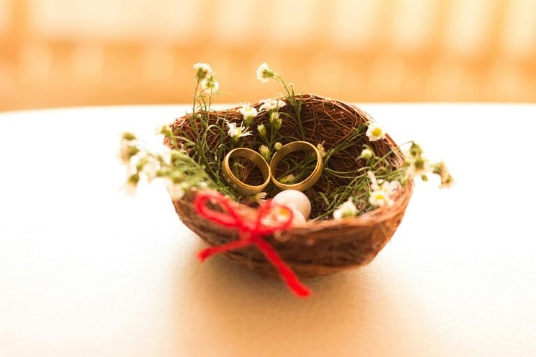Golden wedding rings nestled in a floral basket symbolizing love and commitment.