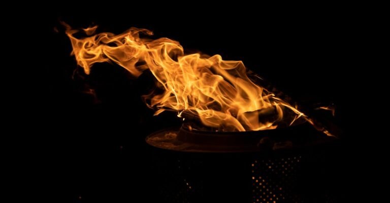 Vibrant flames flicker against a dark backdrop, creating a captivating visual of light and heat.