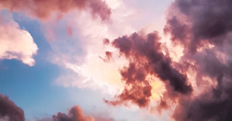A vibrant and dreamy sky with pink and orange clouds during a sunset, showcasing nature's beauty.