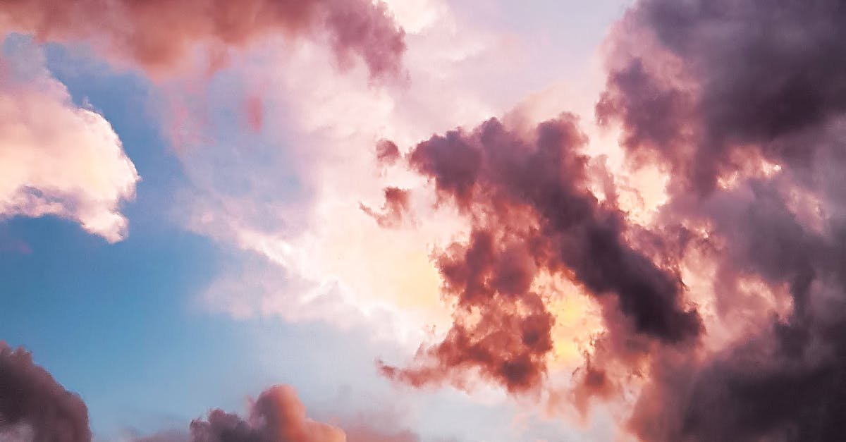 A vibrant and dreamy sky with pink and orange clouds during a sunset, showcasing nature's beauty.