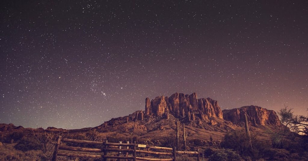A breathtaking night sky above the Superstition Mountains with a starry desert landscape.
