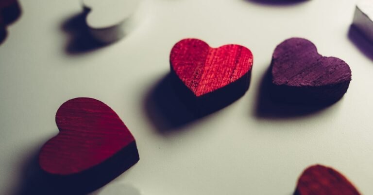 Vibrant wooden heart shapes in red and purple, perfect for Valentine's Day decor.