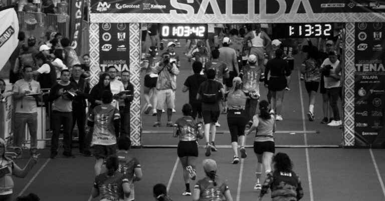 Participants running in a marathon race in Xalapa, Veracruz, captured in black and white.